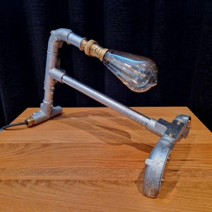 Mechanical style steampunk inspired industrial lamp made from galvanised steel pipe