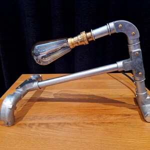 Mechanical style steampunk inspired industrial lamp made from galvanised steel pipe