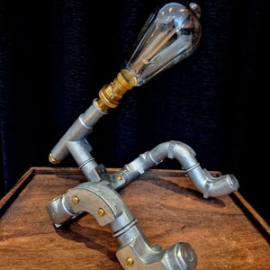 Steampunk Pipe light made from galvanised conduit in a Pipe Man robot style.