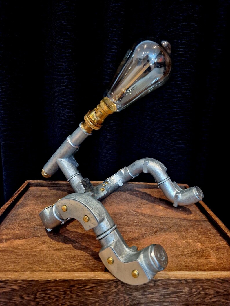 Steampunk Pipe light made from galvanised conduit in a Pipe Man robot style.