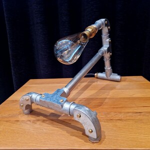 Mechanical style steampunk inspired industrial lamp made from galvanised steel pipe
