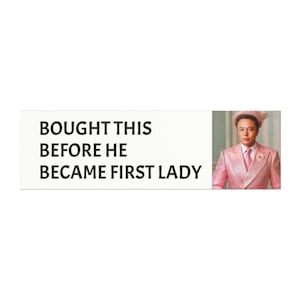 May include: A pink suit with a white shirt and a pink flower on the lapel. The text "BOUGHT THIS BEFORE HE BECAME FIRST LADY" is above the image.