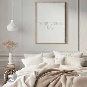 May include: A white bed with a brown blanket and white pillows. A framed picture with the text "Your Design Here" hangs on the wall above the bed.