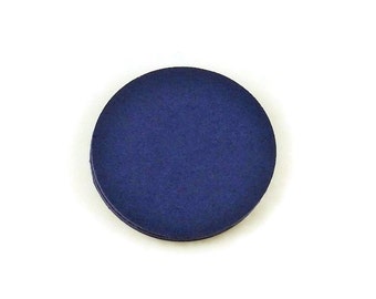 May include: A round, dark blue felt circle.
