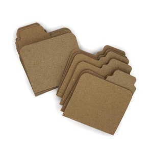 May include: A stack of brown cardboard file folders with tabs. The folders are arranged in a staggered pattern.