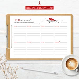 May include: A printable weekly planner with the title "HELD DES ALLTAGS" and the text "Es gibt Helden, es gibt Superhelden und es gibt mich!"  The planner is divided into seven columns for each day of the week, with the days labeled in German. A cartoon cat wearing a red cape and the word "HELD" on its chest is flying across the top of the planner.