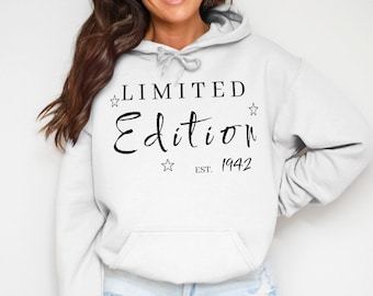 May include: White hooded sweatshirt with the text "LIMITED Edition" in a black script font, with the year "1942" below. The design includes star accents.