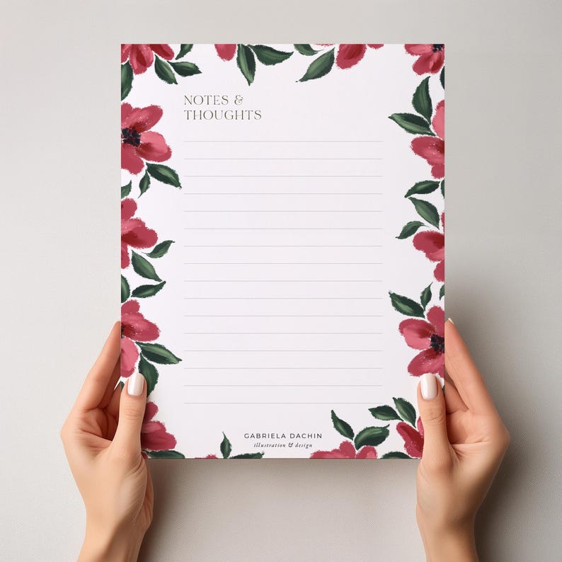 May include: A lined notepad with a floral border of red flowers and green leaves. The words "NOTES & THOUGHTS" are at the top, and the designer's name is at the bottom. The notepad is held by two hands.