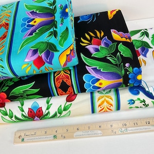 May include: Four fabric samples with floral patterns. One is light blue with vertical stripes and a floral design. Another is black with a floral design. The third is white with a floral design. The fourth is cream with a floral design.
