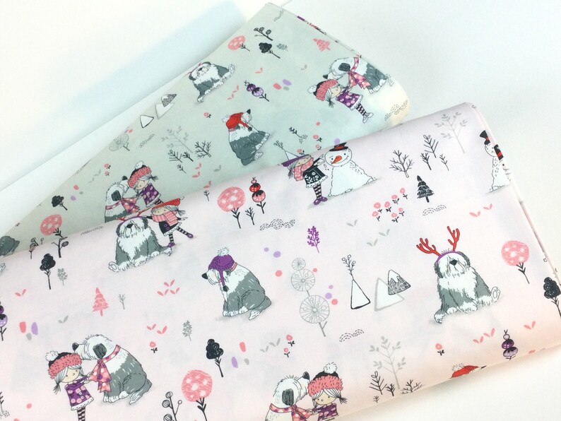 May include: Two rolls of fabric with a winter-themed pattern. One roll is light pink, the other is light green. The pattern features illustrations of children, Old English Sheepdogs, snowmen, trees, and other winter elements.