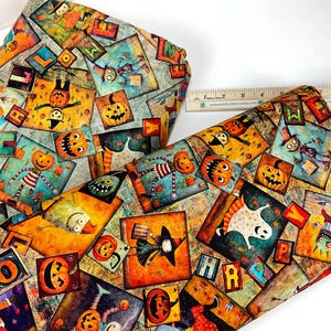 May include: Two rolls of Halloween-themed fabric with a repeating pattern of square illustrations. The illustrations feature jack-o'-lanterns, scarecrows, ghosts, and witches. The fabric has a distressed, vintage look with a color palette of orange, teal, and brown.