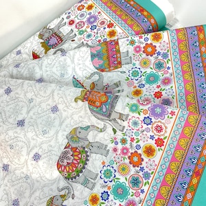 May include: White fabric with a repeating pattern of gray elephants adorned with colorful blankets and floral designs. The border features a turquoise stripe with the text "ELEPHANT CAVALCADE". The fabric is suitable for quilting and crafting.