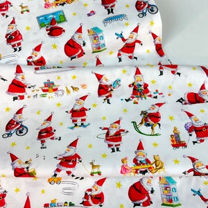 May include: White fabric with a repeating pattern of Santa Claus figures in various poses, including riding a bicycle, skateboarding, and playing musical instruments. The design also features yellow stars and toy illustrations.
