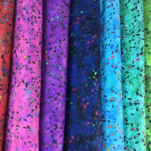 May include: A collection of colorful, rolled fabric bolts. The fabrics display a leaf-like pattern with a variety of colors, including red, purple, blue, and green. The leaves have a metallic sheen, adding a touch of sparkle.