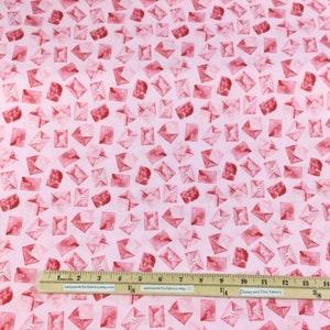 May include: Pink fabric with a repeating pattern of red watercolor envelopes. A ruler shows measurements in inches. The fabric is labeled "LETTERS - SHANNON CHRISTENSEN 51419".