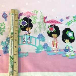 May include: Pink fabric with a repeating pattern of Japanese dolls, bridges, lanterns, and flowers. The dolls have black hair and wear colorful outfits. The design includes a ruler with the text "Sassy and Chic Fabrics".
