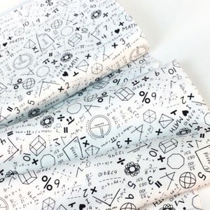 May include: White fabric printed with black math symbols, equations, and the text "I &hearts; MATH". Geometric shapes, numbers, and mathematical operators cover the fabric. The fabric is folded, showing multiple layers.