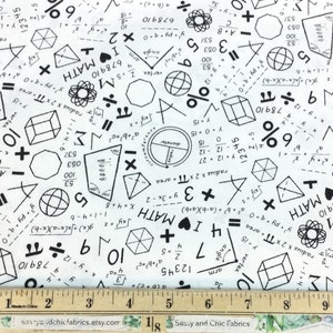 May include: White fabric with a repeating pattern of black math symbols, equations, and geometric shapes. Includes the text "I ❤️ MATH". A ruler in inches is at the bottom. Great for math enthusiasts.