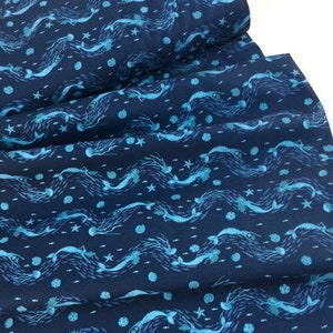 May include: Navy blue fabric with a repeating pattern of stylized mermaids, fish, and starfish in shades of turquoise and light blue. The design features wavy lines, creating an underwater scene. Ideal for sewing projects.