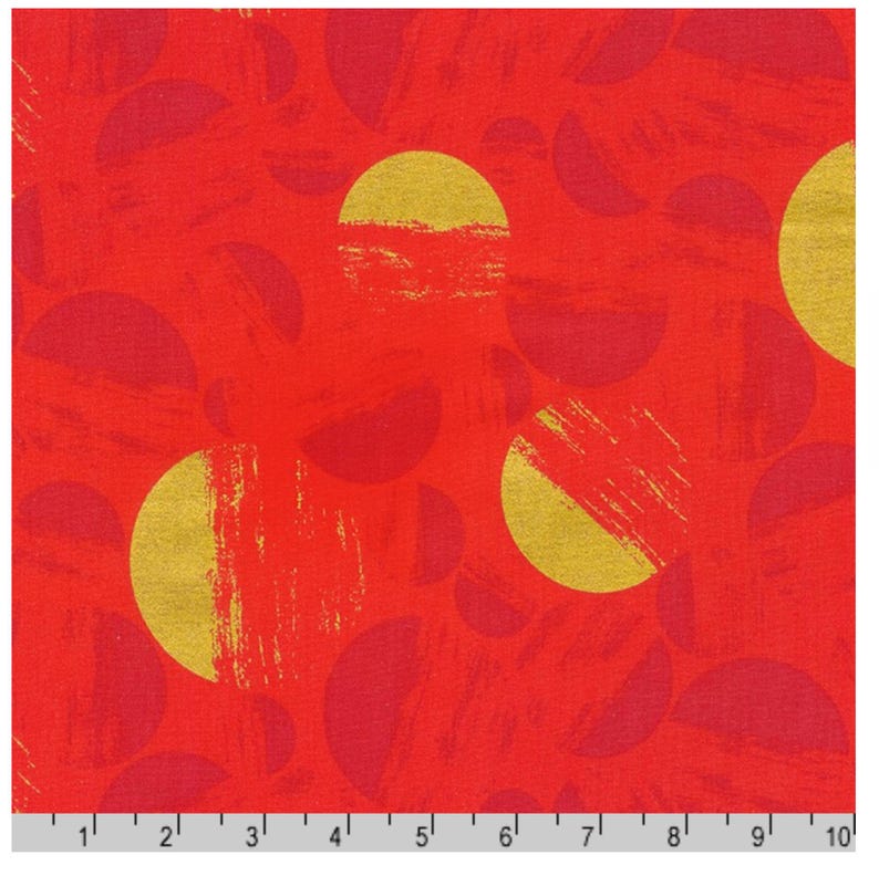 May include: Red fabric with a pattern of gold and red semi-circles and brushstroke textures. The fabric has a vibrant, textured appearance, with a ruler along the bottom edge for scale. The design is bold and eye-catching.
