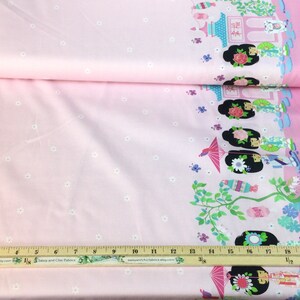May include: Pink fabric with a repeating border design featuring Asian-inspired illustrations of figures, pagodas, and floral elements. The fabric has a light pink background with small white floral accents.