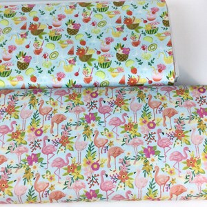 May include: Two rolls of fabric with colorful patterns. One features tropical drinks and fruit on a light blue background. The other has pink flamingos, flowers, and foliage on a light blue background. Both fabrics are likely cotton or a similar material.