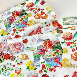 May include: White fabric with a colorful food-themed print. The design includes illustrations of various foods like tomatoes, lemons, and jars of preserves. The fabric also features the word "SALT" and a small card that says "Sassy and Chic Fabrics".