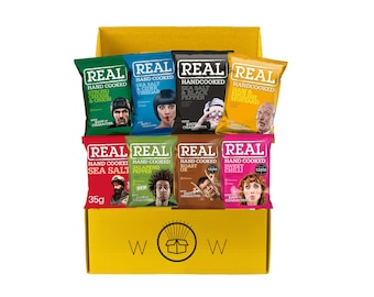 May include: A yellow cardboard box filled with bags of Real Hand Cooked potato chips. The bags are various colors, each with a different flavor and a picture of a person. Flavors include Sea Salt, Cheese & Onion, and Sweet Chili.