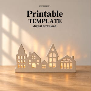 May include: A beige ceramic-style house silhouette candle holder with cut-out windows and doors. The text above reads ceramixis Printable TEMPLATE digital download. The structure features multiple roof shapes and emits a warm internal glow.