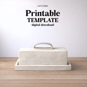 May include: An off-white rectangular butter dish with a handle, on a matching tray. The dish is on a wooden surface. The text "Printable TEMPLATE - digital download-" is above the dish.