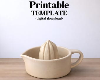 May include: A beige ceramic citrus juicer with a central reamer and a side handle. The text above reads ceramixis, Printable TEMPLATE, and digital download. The object is a kitchen tool designed for extracting juice from citrus fruits.
