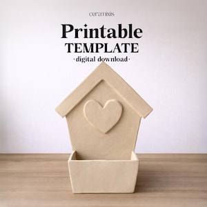 May include: A beige, house-shaped planter with a heart cutout, and a rectangular base. The image includes the text "Printable TEMPLATE - digital download-" and the brand name "ceramixis" at the top.