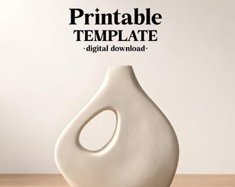 May include: Cream-colored ceramic vase with a unique teardrop shape and an oval cutout. The vase is on a wooden surface. The image includes the text "Printable TEMPLATE - digital download-" and the brand name "ceramixis".
