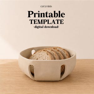 May include: A beige ceramic bowl with cut-out rectangular openings along the base, containing several slices of bread. The text "ceramixis Printable TEMPLATE digital download" is displayed above the bowl in black lettering.