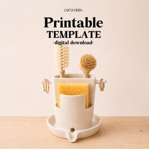 Puede incluir: Un organizador de fregadero de cerámica color crema con soporte para esponja integrado y dos clavijas laterales con anillos dorados. El organizador contiene un cepillo para botellas y un cepillo redondo. Texto: ceramixis, Printable TEMPLATE, digital download.