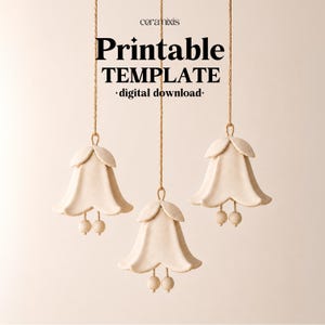 May include: Three off-white bell-shaped ornaments hanging from thin brown strings. Each bell features a petal-like top and two small spherical clappers at the bottom. The text "ceramixis Printable TEMPLATE digital download" is centered above.