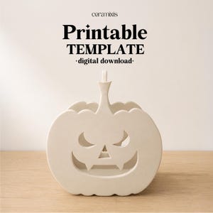 May include: A cream-colored, flat-surfaced pumpkin cutout with a carved jack-o'-lantern face featuring triangular eyes and a wide, toothy grin. The text above reads ceramixis, Printable TEMPLATE, and digital download in black lettering.