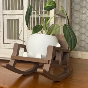 May include: A set of three ceramic mugs with a speckled, matte finish. The mugs are in shades of cream, light gray, and dark gray. Each mug has a simple, minimalist design, perfect for coffee or tea.