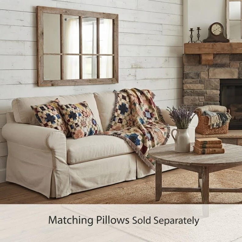 May include: A cream-colored sofa featuring two patterned throw pillows with a star-like design and a matching throw blanket draped over the side. The text "Matching Pillows Sold Separately" is printed at the bottom of the image.
