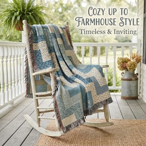 May include: A wooden rocking chair draped with a blue and cream patterned throw blanket featuring a chevron design and fringed edges. The text "COZY UP TO FARMHOUSE STYLE Timeless & Inviting" is displayed in the upper right corner of the image.