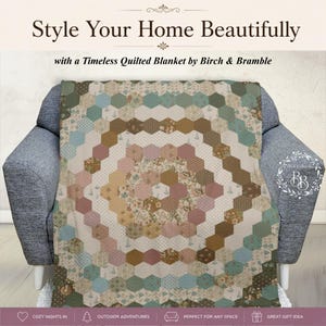 May include: A quilted blanket featuring a hexagonal patchwork pattern in shades of sage green, dusty rose, brown, and cream. The quilt displays various floral and geometric prints within the hexagons, with the text Style Your Home Beautifully.