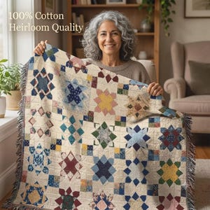 May include: A woven cotton throw blanket featuring a repeating star pattern in various colours including blue, yellow, red, and green on a cream background. The blanket has fringed edges and the text 100% Cotton Heirloom Quality is visible.