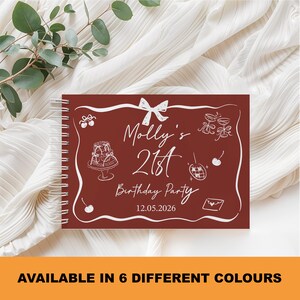 May include: A maroon spiral-bound notebook with white illustrations and text. The cover reads "Molly's 21st Birthday Party" with a date. The bottom of the image says "AVAILABLE IN 6 DIFFERENT COLOURS".