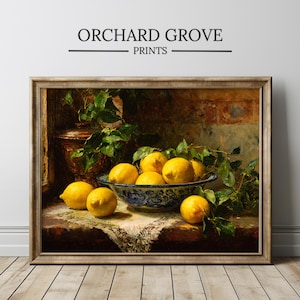 May include: Framed print of a still life featuring a bowl of lemons. The bowl is blue and white, surrounded by greenery and additional lemons. The print is labeled "ORCHARD GROVE PRINTS".