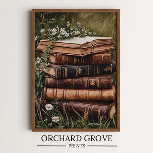 May include: A stack of vintage books with leather covers and gold lettering, surrounded by white wildflowers and green foliage. The books are arranged in a pile, with the top book open and a bouquet of wildflowers resting on it.