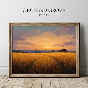 May include: Framed landscape print featuring a golden wheat field at sunset. The artwork displays a farmhouse silhouette, birds in flight, and the text "ORCHARD GROVE PRINTS" at the top. The frame is a warm, golden color.