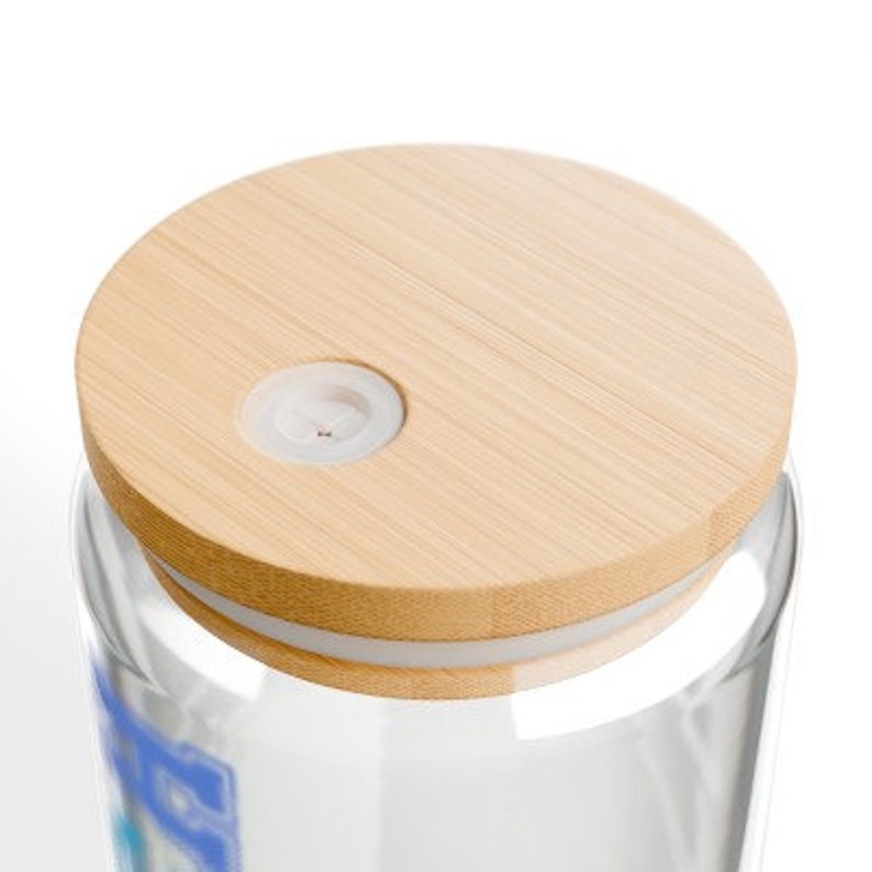 May include: A clear glass jar with a wooden lid. The lid has a small hole in the center.