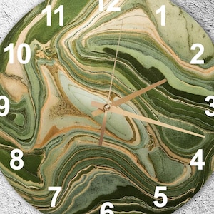 May include: Round wall clock with a green and gold marbled design. The clock face features white numerals and gold-colored hands. The clock's design resembles natural stone, adding a touch of elegance to any room.