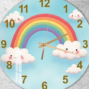 May include: A round wall clock with a light blue background featuring a rainbow and cartoon clouds. The clock hands are gold, and the numbers are in a gold color. The clock face has a glossy finish.