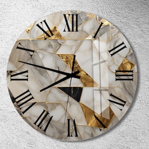 May include: A round wall clock with a white marble and gold geometric design. Roman numerals mark the hours. The clock has black hands.